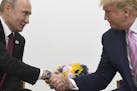 President Donald Trump, right, shakes hands with Russian President Vladimir Putin during a bilateral meeting on the sidelines of the G-20 summit in Os