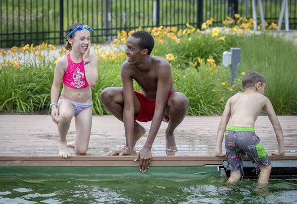 Webber Pool lifeguard Mohamed Mohamed gave swimming lessons to Mahira McClellan Sostek, 9, along with other children at the pool Tuesday in Minneapoli