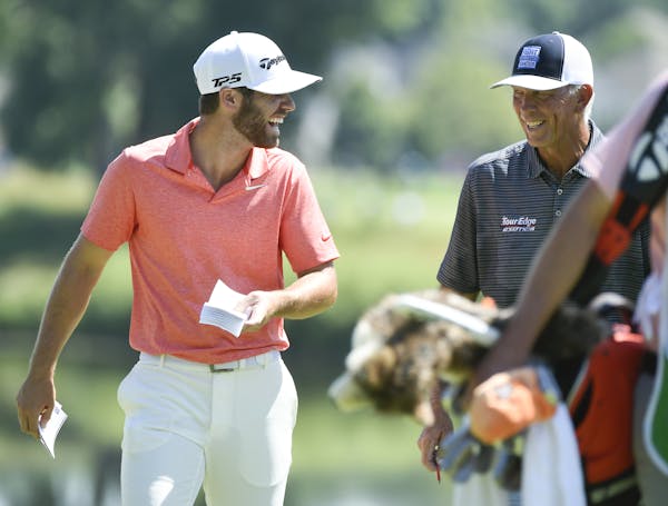 Matthew Wolff, left, joked with Tom Lehman as they walked to the eighth hole following a birdie by Wolff and an eagle by Lehman on the seventh hole.