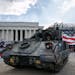 An Army driver with the 3rd Infantry Division, 1st Battalion, 64th Armored Regiment, drives a Bradley Fighting Vehicle into place by the Lincoln Memor