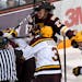 Minnesota-Duluth Bulldogs forward Riley Tufte (27) and Minnesota Golden Gophers forward Darian Romanko (26) tussled during the third period of a game 