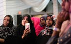 Munira Mohmed, center, and Habiba Mohamed, right, listened at the Safari restaurant in Minneapolis as speakers shared memories of activist and journal