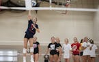Olivia Tjernagel served the ball during the first day of volleyball practice Monday at Mayer Lutheran High School. Photo: Jerry Holt • Jerry.holt@st