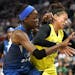 Minnesota Lynx center Temi Fagbenle (14) and Seattle Storm forward Alysha Clark (32) battle for a rebound during the first half.