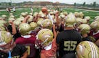 Lakeville South’s football team hit the field with a team huddle before the first day of practice Monday morning. Photo: BRIAN PETERSON •brian.pet