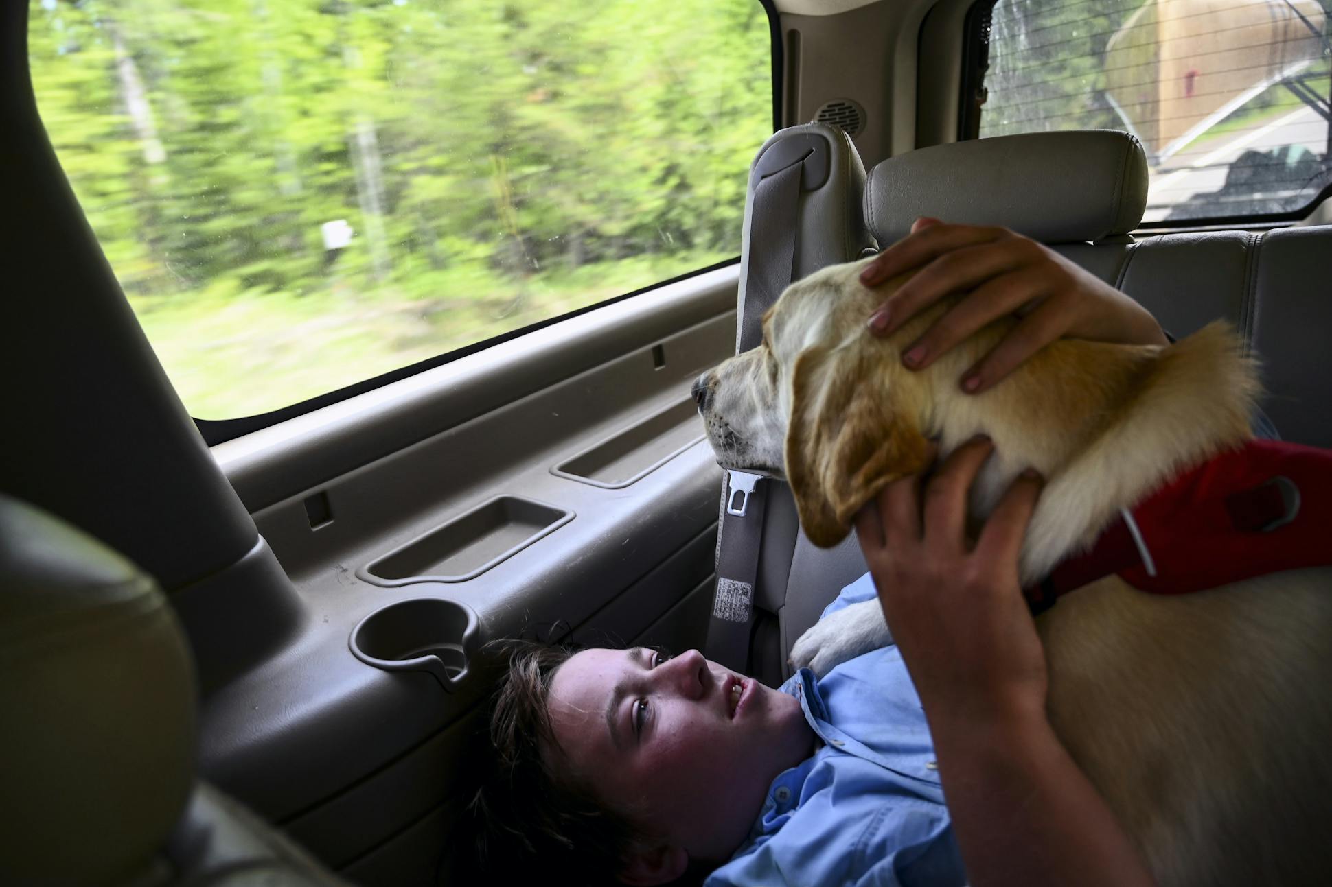 Aidan Jones rested with his dog, Crosby, as they headed down the Arrowhead Trail after ending their trip.