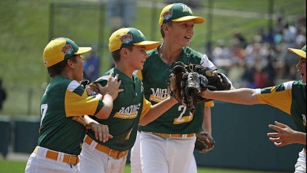 Jaxon Knutson, second from right, celebrates with Carson Timm, left, and Jack Brandi, center, after making a diving catch to end the fifth inning of t