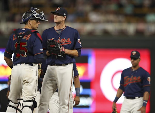 Minnesota Twins starting pitcher Kyle Gibson grimaced while waiting to be taken out of the game after walking Cleveland's Yasiel Puig to load the base