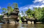 Carved sandstone bluffs, cliffs, canyons and gorges line the Wisconsin River at the Wisconsin Dells. The Sugar Bowl is a free-standing rock formation 