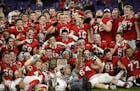 Lakeville North celebrated with their 6A championship trophy after defeating Eden Prairie 28-21 Friday night. ] Aaron Lavinsky ¥ aaron.lavinsky@start