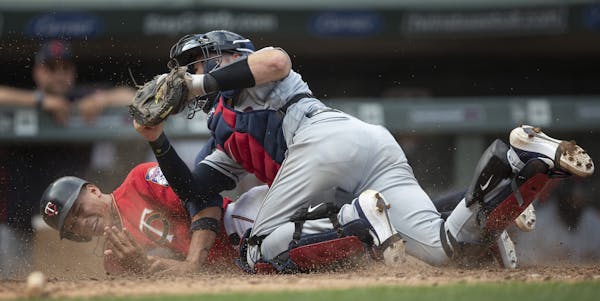 Cleveland catcher Kevin Plawecki tagged out Twins pinch runner Ehire Adrianza as he tried to score on a double by Marwin Gonzalez in the ninth inning
