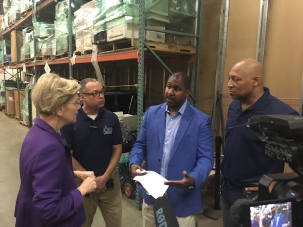 Sen. Elizabeth Warren spoke with Better Futures Minnesota President Thomas Adams and other staff at the nonprofit’s Minneapolis warehouse Tuesday, w