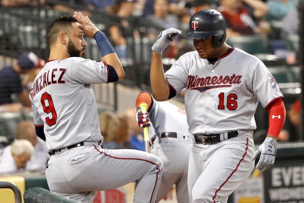 The Twins' Jonathan Schoop celebrates his home run off White Sox starting pitcher Lucas Giolito with Marwin Gonzalez during the second inning