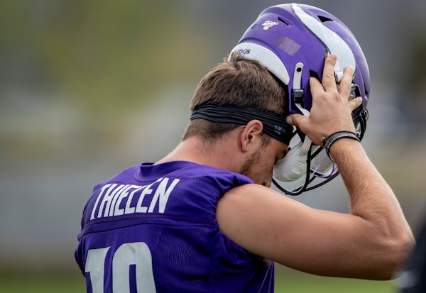 Vikings wide receiver Adam Thielen put on his helmet before practice. An NFL rule change insists all players' helmets be tested and certified jointly 