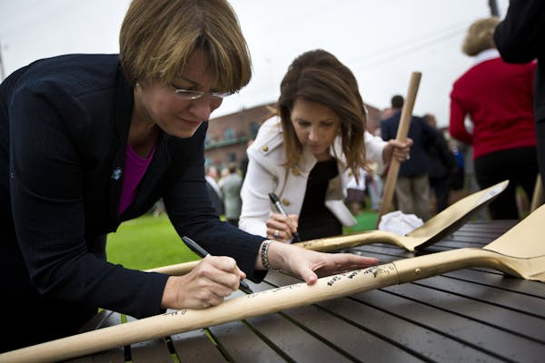 Sen. Amy Klobuchar and Rep. Michele Bachmann signed shovels at a groundbreaking ceremony for the new St. Croix River Bridge in Stillwater in 2013.