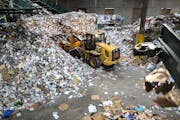 Workers move recyclables at the Eureka Recycling facility in Minneapolis.