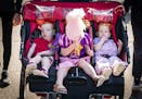 Siblings from Plymouth get the triple stroller treatment on busy Judson Avenue. From left is Michael Gust, 2, Monley, 3, who was enjoying some cotton 