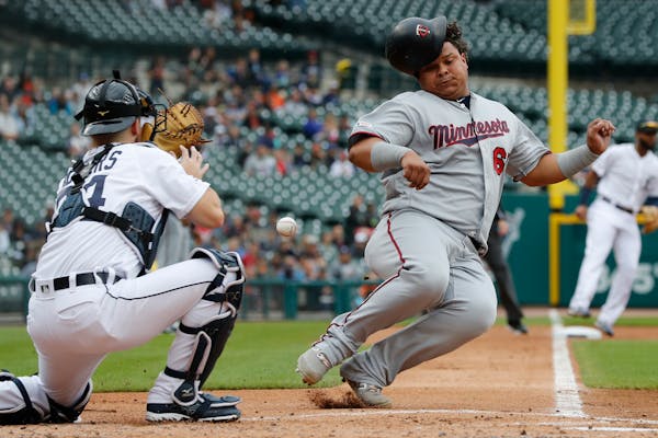 Willians Astudillo beat the throw to Tigers catcher Jake Rogers to score from second on a single by teammate Jorge Polanco during the second inning of