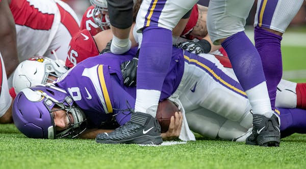 Vikings quarterback Kirk Cousins is taken down in the second quarter