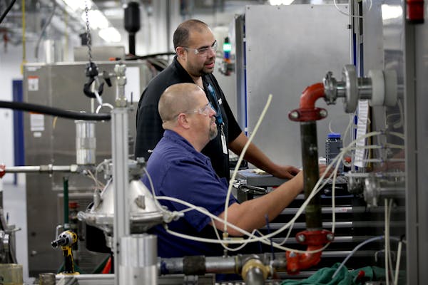 Workers test filtration equipment at Donaldson's plant in Bloomington in this file photo.