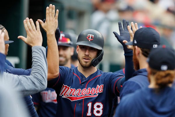 The Twins' Mitch Garver is greeted in the dugout after his solo home run during the first inning