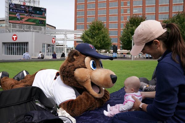 T.C. Bear sat with Chrissie Olson and her 5-month-old daughter during a free "Postseason Push" party Thursday, which watched the Twins play the Tigers