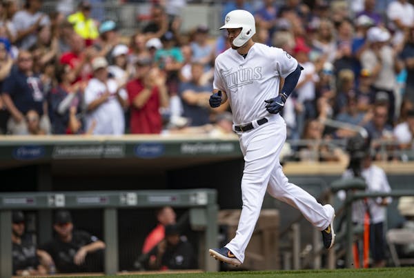Minnesota Twins first baseman C.J. Cron (24) jogged from third base to home plate after hitting a three-run homer in the fourth inning on Sunday.