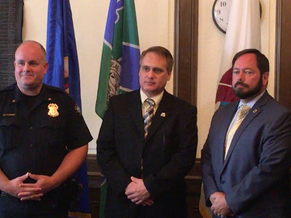 Duluth Police Chief Mike Tusken, DEA Special Agent in Charge Richard Salter Jr. and DEA Special Agent in Charge Kenneth Solek look on during a news co