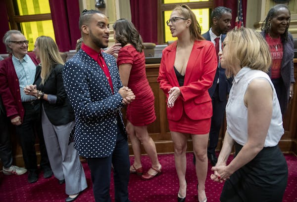 Minneapolis City Council Member Phillipe Cunningham, left, congratulated Ramona Falls, center, and Jayne Swift of the Sex Worker Outreach Project afte