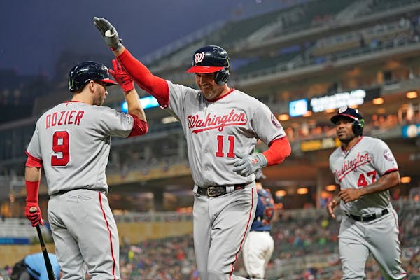 The Nationals’ Ryan Zimmerman (11) got a high-five from teammate and former Twin Brian Dozier after Zimmerman’s two-run homer in the third inning.
