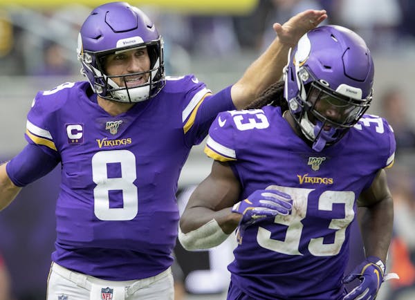 Minnesota Vikings quarterback Kirk Cousins (8) celebrated with Dalvin Cook (33) after scoring on a quarterback sneak in the second quarter.
