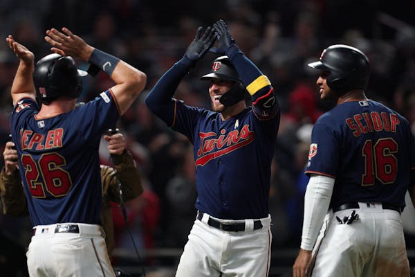 Twins catcher Mitch Garver celebrated with Max Kepler and Jonathan Schoop after hitting a three-run home run in the seventh inning.