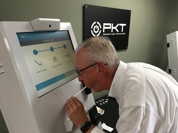 General Manager Patrick McKinney of Edina-based Precision Kiosk Technologies demonstrates a breathalyzer kiosk.