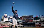 Twins shortstop Ehire Adrianza played catch to warm up while the Twins waited for batting practice to start for Game 2
