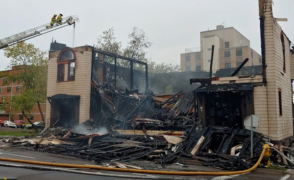 FILE- Firefighters work the scene of an fire that engulfed and destroyed a synagogue in downtown Duluth, Minn., Monday, Sept. 9, 2019.