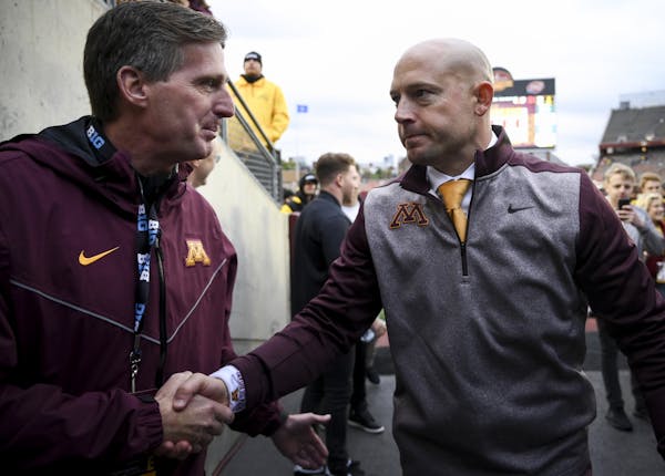 Gophers football coach P.J. Fleck shook hands with AD Mark Coyle following the victory over Illinois this season.