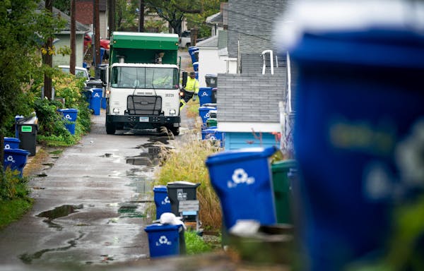 Waste Management worker Daniel Westerhaus collected trash from the alleys of the Snelling Hamline neighborhood of St Paul's yellow zone on the first d
