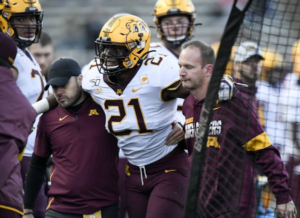 Gophers linebacker Kamal Martin (21) was helped to the sideline and later carted off the field Saturday.
