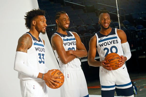 Andrew Wiggins, center, is enjoying himself more. "But the joy has always been there. I’ve never been on the court not wanting to play,” he said.