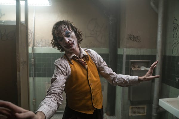 This image released by Warner Bros. Pictures shows Joaquin Phoenix in a scene from the film, “Joker.” (Niko Tavernise/Warner Bros. Pictures via AP