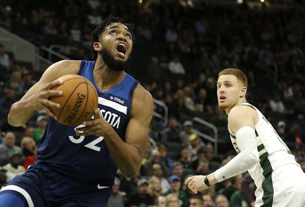 Timberwolves star Karl-Anthony Towns drove past Milwaukee’s Donte DiVincenzo during the second half Thursday.