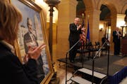 Sen. Tina Smith and Gov. Tim Walz applauded as former Gov. Mark Dayton’s official Capitol portrait was unveiled during a ceremony Thursday.