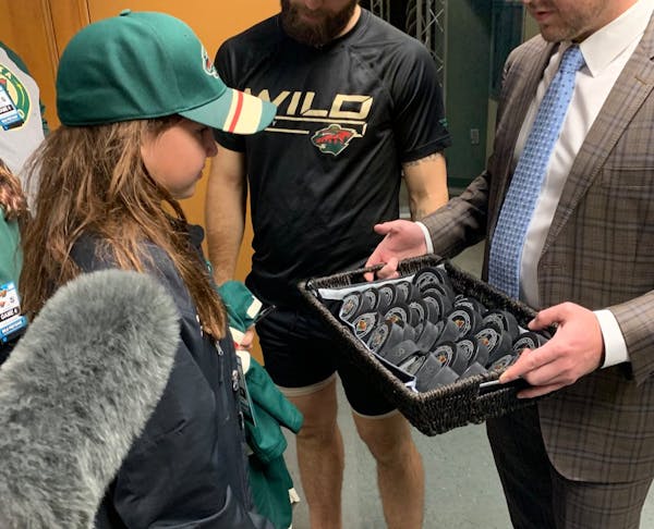 Emily Wiltzius had two pucks and gave them both away. She received 26 more from the Minnesota Wild for her kindness.