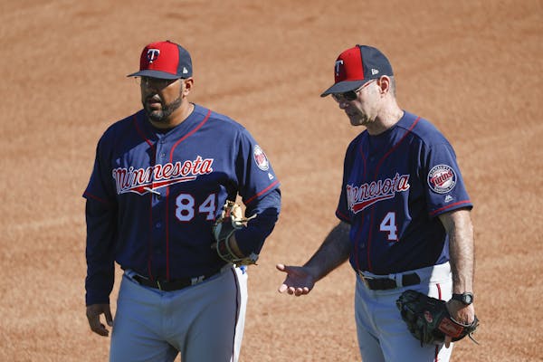 New Twins hitting coach Edgar Varela (left, with former manager Paul Molitor) spent 10 years with the Pirates before joining the Twins' minor league s