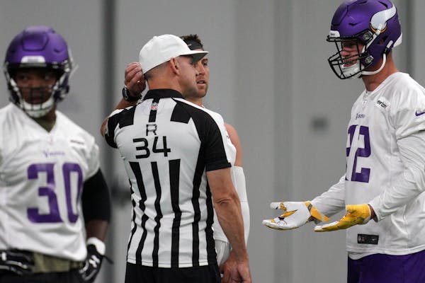 Vikings tight end Kyle Rudolph talked with NFL official Clete Blakeman during a minicamp session in June.