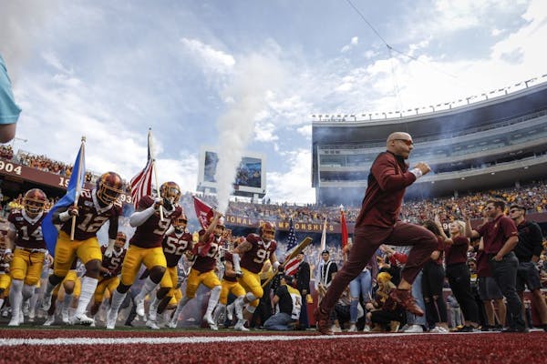 Minnesota head coach P.J. Fleck races onto the field with his team before a game against Georgia Southern in September. The schedule gets increasingly