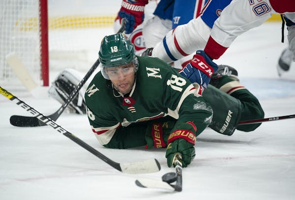 The Wild's Jordan Greenway controlled the puck on the ice while Montreal’s Jeff Petry (26) defended on Oct. 20 at Xcel Energy Center.
