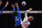 Minnetonka middle hitter Sonia Dahlin (9) went up for a hit as Eagan setter Kennedi Orr (2) attempted a block in the first game of the Class 3A volley