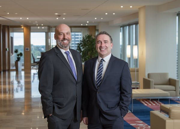 Lathrop Gage Managing Partner Cameron Garrison (left) and Gray Plant Mooty Managing Officer Michael Sullivan Jr. (right) will help lead their firms' m