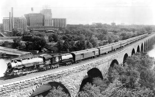 Great Northern Railway’s first Empire Builder is pictured on the Stone Arch Bridge crossing the Mississippi River, likely in the 1920s or 1930s.